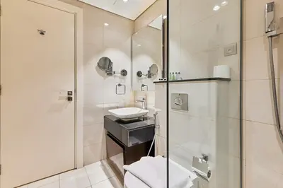 a bathroom with a shower and a sink at Majesty Stay 2BR in Dubai