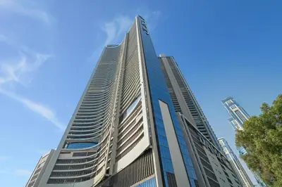 a tall building with a blue sky in the background at The Iconic Stay 2BR in Dubai