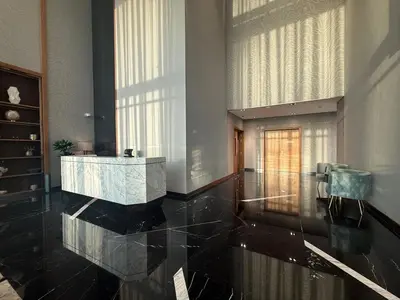 a lobby with a marble counter and a large window at The Iconic Stay 2BR in Dubai