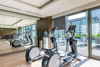 a gym with cardio equipment in a building at Family Friendly Studio in Dubai City Views Pool Free Parking in Dubai