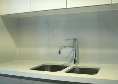 a stainless steel sink in a white kitchen at Velvet Rose with Burj and canal view 2Bedrooms in Solbay in Dubai