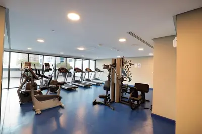 a gym with treadmills and ellipticals in a building at Velvet Rose with Burj and canal view 2Bedrooms in Solbay in Dubai
