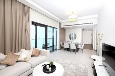 a living room with a white couch and a table at Velvet Rose with Burj and canal view 2Bedrooms in Solbay in Dubai