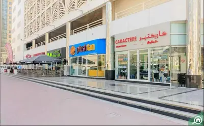 an empty shopping mall with tables and chairs in it at Platinum Budget Stay Dubai In Tecom Near Metro in Dubai