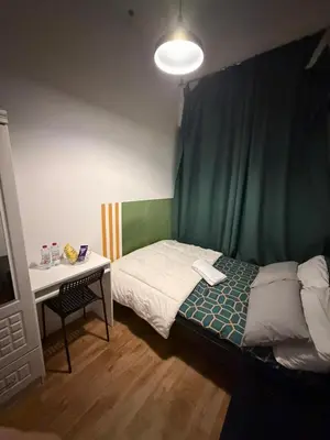 a small bedroom with a bed and a desk at Platinum Budget Stay Dubai In Tecom Near Metro in Dubai