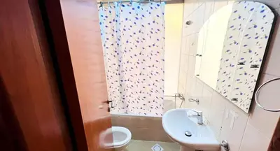 a bathroom with a sink and a shower curtain at Peaceful Budget Stay Dubai In Tecom Near Metro in Dubai