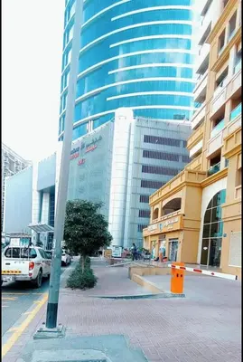 a city street with a large tall building at Peaceful Budget Stay Dubai In Tecom Near Metro in Dubai
