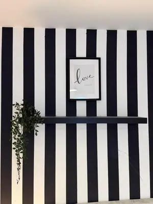 a black and white stripe wall with a shelf at Royal Budget Stay Dubai In Tecom Near Metro in Dubai