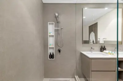 a bathroom with a shower and a sink at Full Burj Khalifa & Fountain View 60th Floor Sky Luxury 2BHK 4 mins Walk to Dubai Mall Downtown in Dubai