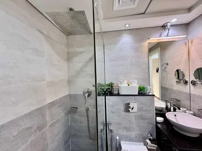 a bathroom with a shower and a sink at Refined Urban Studio Walk to Circle Mall in Dubai