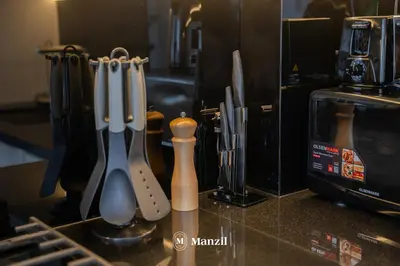 a group of knives on a counter in a kitchen at Modern 1BR with Stunning Lake View in Business Bay in Dubai