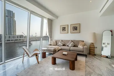 a living room with a couch and a table at Modern 1BR with Stunning Lake View in Business Bay in Dubai