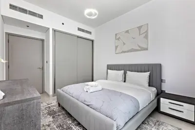 a bedroom with a large white bed in a room at Beachfront 1BR Retreat Beach Isle Tower 01 in Dubai