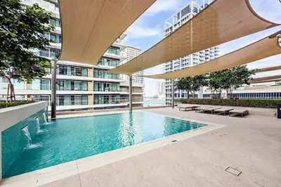 a swimming pool in the middle of a building at Beachfront 1BR Retreat Beach Isle Tower 01 in Dubai
