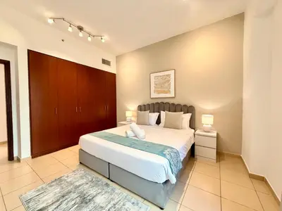a bedroom with a large bed in a room at Brand-New 4BR on JBR Beach Near metro, mall By Sunkissed Holiday Homes in Dubai