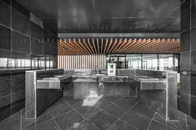 a bathroom with a sink in a room with black tiles at Bloomfields STU in Business Bay, Bayz by Danube in Dubai