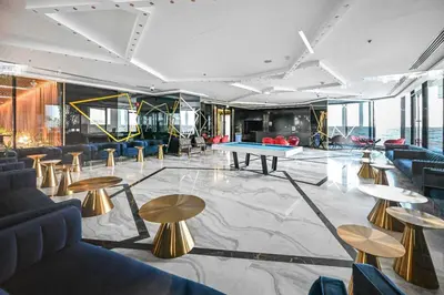 a room with tables and a ping pong table at Bloomfields STU in Business Bay, Bayz by Danube in Dubai