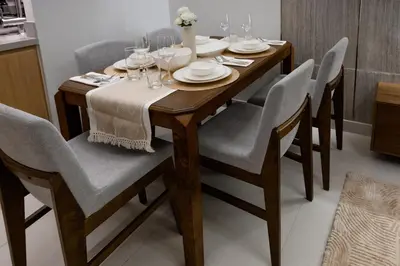 a dining room table and chairs with wine glasses at Stylish 2BR Connected to Dubai Mall with Full Burj Khalifa View in Dubai