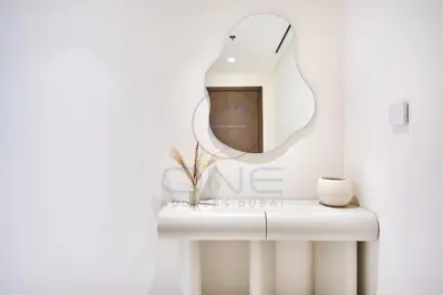 a bathroom with a mirror and a white sink at Elegant beachfront living at Emaar Beachfront DXB! in Dubai