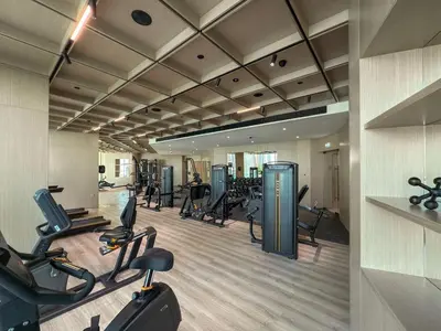 a gym with treadmills and cardio equipment in a building at Chic 1BR Retreat with Private Pool and Balcony in JVC in Dubai