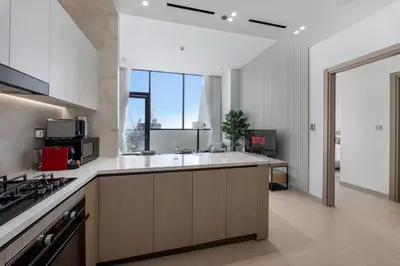 a kitchen with a sink and a counter top at Chic 1BR Retreat with Private Pool and Balcony in JVC in Dubai