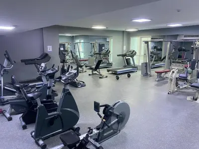 a gym with many exercise equipment in a room at Dubai Marina - 1BHK Apartment near Dubai Metro in Dubai