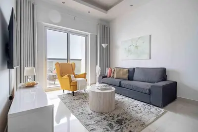 a living room with a couch and a table at Frank Porter - Hera Tower in Dubai