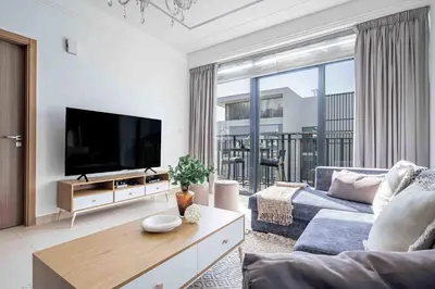 a living room with a couch and a tv at Frank Porter - Sunrise Legend in Dubai