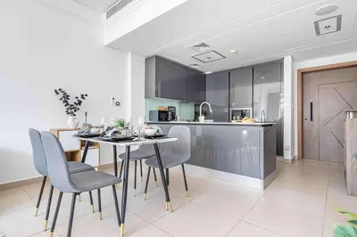 a kitchen and dining room with a table and chairs at Frank Porter - Sunrise Legend in Dubai