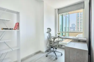 an office with a desk and a chair and a window at Frank Porter - Al Majara, Dubai Marina in Dubai