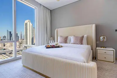 a bedroom with a large white bed and a large window at Frank Porter - Vida Dubai Mall, Downtown in Dubai