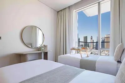 a hotel room with two beds and a mirror at Frank Porter - Vida Dubai Mall, Downtown in Dubai