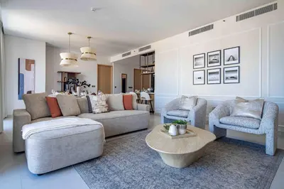 a living room with a couch and two chairs and a table at Frank Porter - Vida Dubai Mall, Downtown in Dubai