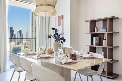 a dining room table with chairs and a large window at Frank Porter - Vida Dubai Mall, Downtown in Dubai