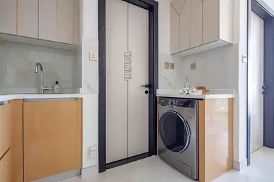 a kitchen with a washing machine in a kitchen at Frank Porter - Skyz By Danube in Dubai