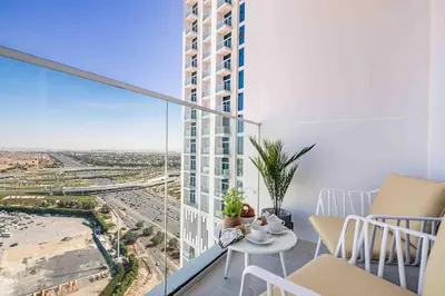 an apartment balcony with a view of a city at Frank Porter - Skyz By Danube in Dubai