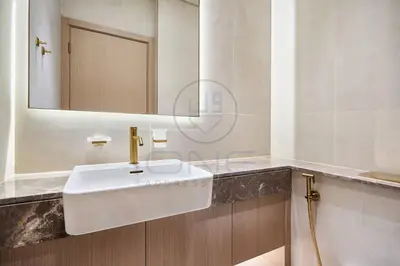 a bathroom with a white sink and a mirror at Binghatti Royale premium 1BR with Jacuzzi in Dubai
