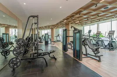 a gym with several treadmills and exercise bikes at Binghatti Royale premium 1BR with Jacuzzi in Dubai
