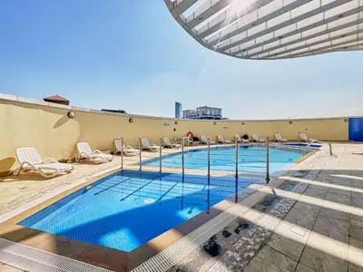 a swimming pool on the roof of a building at Frank Porter - Goldcrest Executive in Dubai
