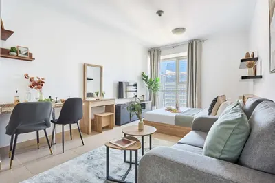 a living room with a couch and a table at Frank Porter - Goldcrest Executive in Dubai