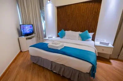 a hotel room with a large bed with towels on it at Damac Downtown 1 BHK apartment with Burj Khalifa view in Dubai