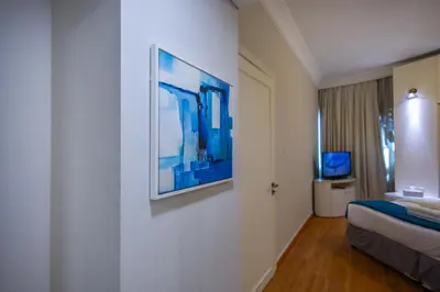 a hotel room with a large painting on the wall at Damac Downtown 1 BHK apartment with Burj Khalifa view in Dubai