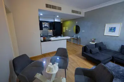 a living room with a couch and a table at Damac Downtown 1 BHK apartment with Burj Khalifa view in Dubai