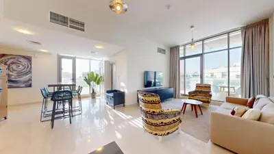 a living room with a couch and a table and chairs at Luxury 2br Penthouse Spacious in Dubai