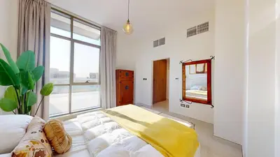 a bedroom with a bed and a large window at Luxury 2br Penthouse Spacious in Dubai