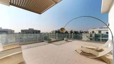 a balcony with chairs and a view of a city at Luxury 2br Penthouse Spacious in Dubai