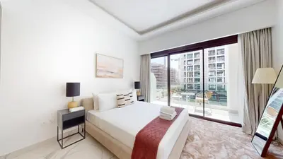 a bedroom with a large bed and a large window at Luxurious Chic Comfort Studio in Dubai