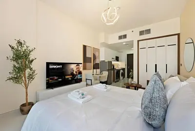 a bedroom with a white bed and a tv at Bloomfields Stunning STU, Elz By Danube, Dubai in Dubai