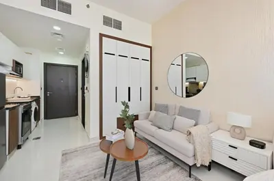 a living room with a white couch and a mirror at Bloomfields Stunning STU, Elz By Danube, Dubai in Dubai