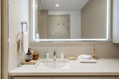 a bathroom with a sink and a mirror at Serene Creek Harbour Escape with Burj Khalifa View in Dubai